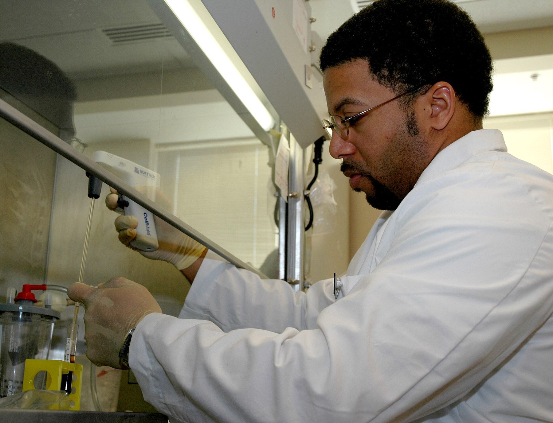 Analyst pipetting in a pharmaceutical laboratory